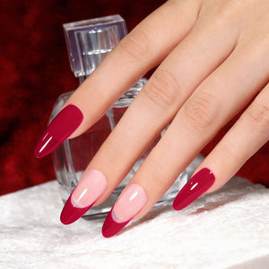 Deep burgundy red gel nail polish on manicured nails with a glossy finish, showcasing nail art design.
